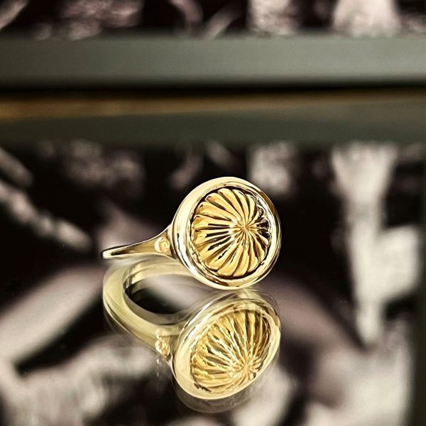 Silver signet ring with golden detail and yellow sapphire