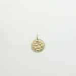 Colgante artesanal de oro con forma redonda y grabado floral de estilo antiguo, sobre fondo blanco neutro