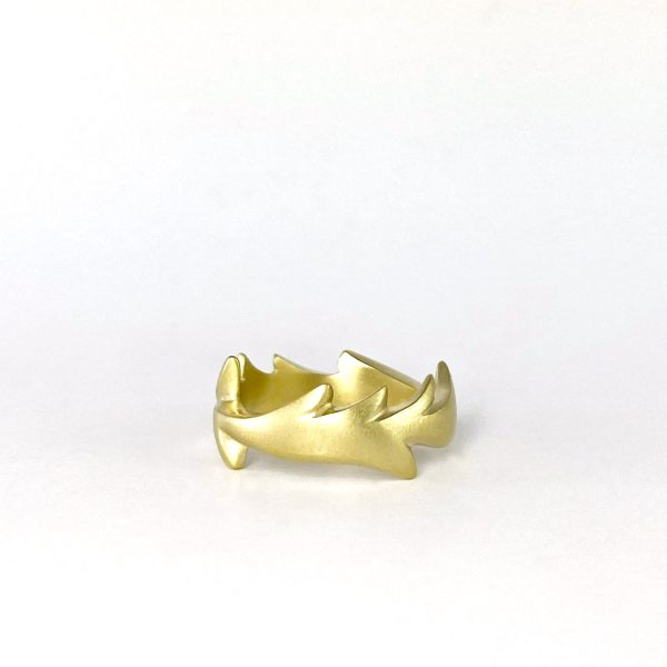 Anell de plata xapada en or amb forma ondulada i moviment orgànic.